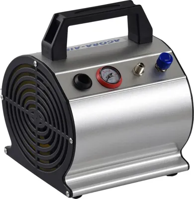 A silver and black airbrush compressor with a pressure gauge and a blue knob on top.
