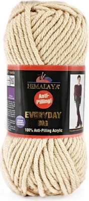 A ball of beige yarn with a product label.