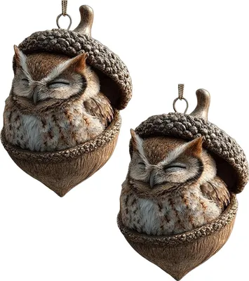 Two owl ornaments nestled in acorns, displayed against a white background.