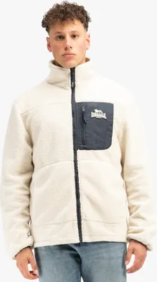 A man wearing a cream and navy fleece jacket.