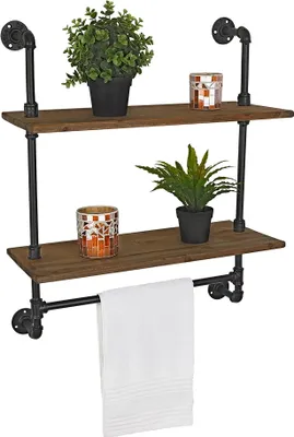 A two-tiered industrial-style shelf with a towel bar, decorated with plants and candles.
