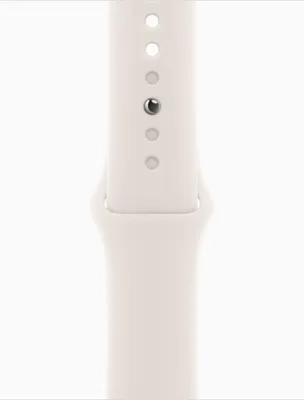 A close-up view of a white watch band with a silver pin.