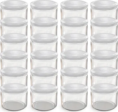 A grid of clear glass jars with white lids.
