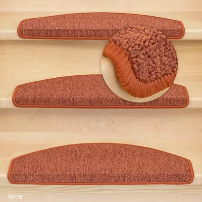 Several orange stair mats are placed on wooden stairs.