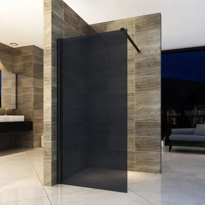 A modern bathroom with a black glass shower enclosure, marble-like tiles, and a view of a nighttime cityscape.