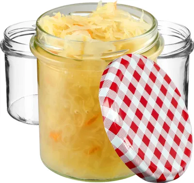 Three glass jars, one filled with sauerkraut, and a red and white checkered lid.