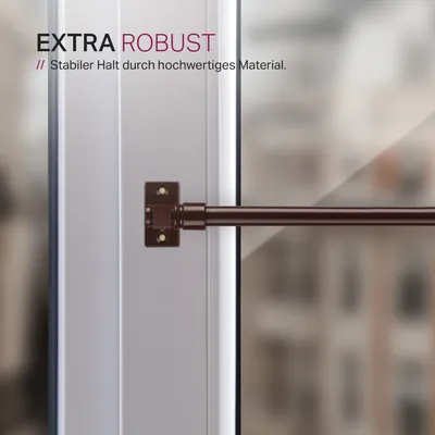 Close-up of a curtain rod bracket and rod attached to a window frame.