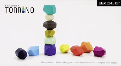A product shot of a wooden stacking game with several pieces stacked and others scattered around.