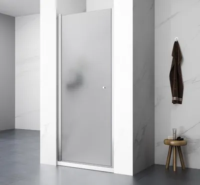 A modern bathroom with a frosted glass shower door, marble-patterned walls, and a dark gray floor.
