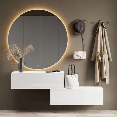A modern entryway with a round mirror, a white floating shelf and bench, and hanging accessories.