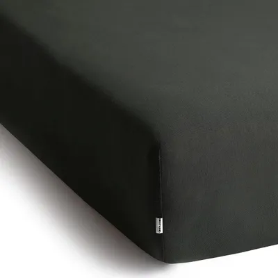 A close-up view of a dark gray fitted sheet, showing the corner and a small tag.
