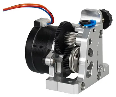 A close-up view of a 3D printer extruder with visible gears and a motor.