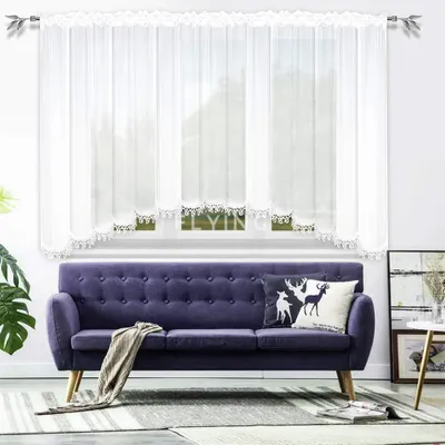 A living room scene with a sofa and curtains.