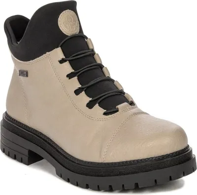 A single beige and black boot is shown against a white background.