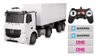 A white remote-controlled truck with a trailer, a remote control, and three shipping containers.