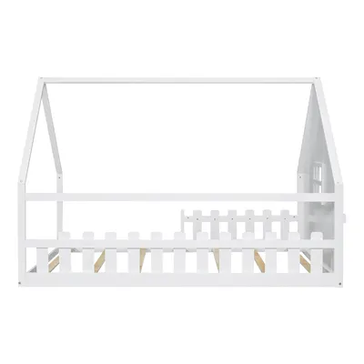 A white wooden house-shaped bed frame with a fence-like railing.