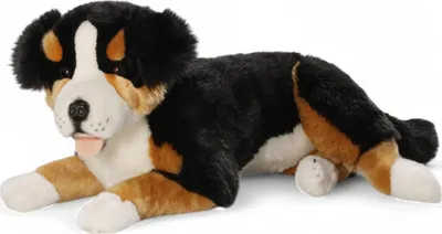 A plush toy dog lying down on a white background.