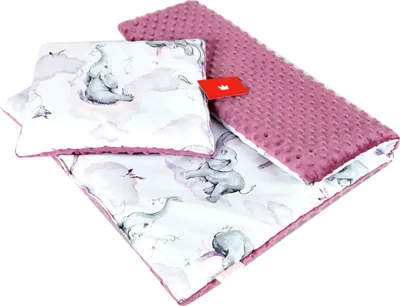 A baby blanket and pillow set with an elephant pattern.