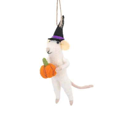 A felt ornament of a mouse wearing a witch hat and holding a pumpkin, suspended against a white background.