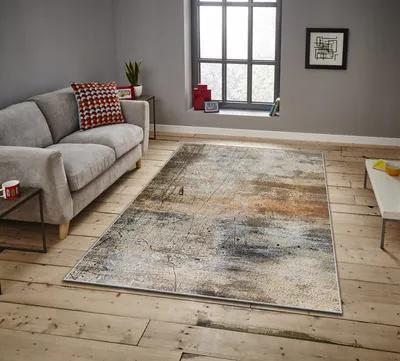 A living room scene with a sofa and a rug.