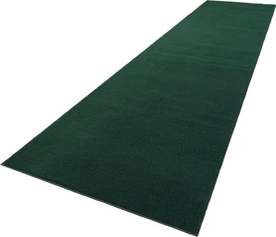 A dark green rug is shown from a diagonal angle against a white background.