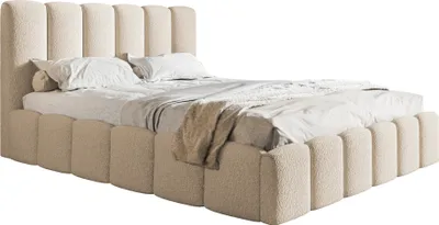 A bed with a beige upholstered headboard and frame, shown from a side angle.