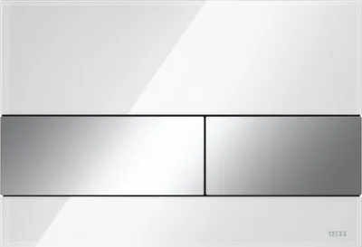 A white toilet flush plate with two silver buttons, set against a white background.