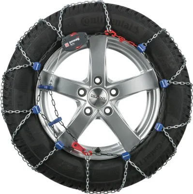 A close-up studio shot of a car snow chain fitted onto a car wheel.