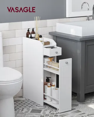 A white slim cabinet next to a toilet and under a bathroom sink.