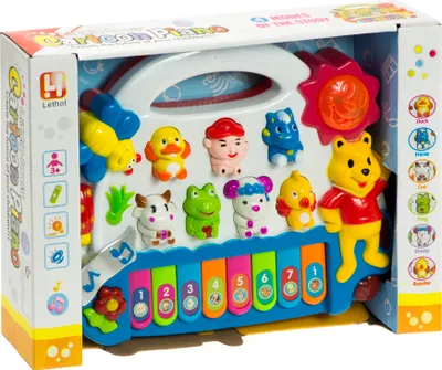 A toy piano with animal figures inside its retail packaging.