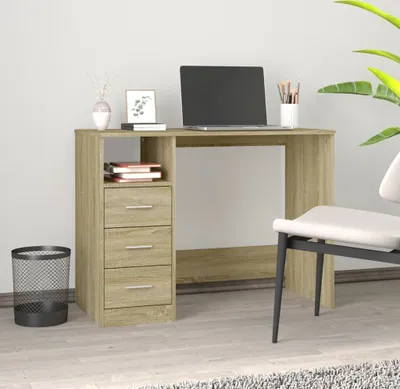 A desk with a laptop and office supplies in a room.