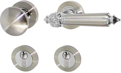 A set of door hardware, including a round doorknob, a lever handle with decorative accents, and two keyhole escutcheons, arranged against a white background.