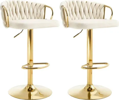 Two cream-colored bar stools with gold legs and accents, shown against a white background.