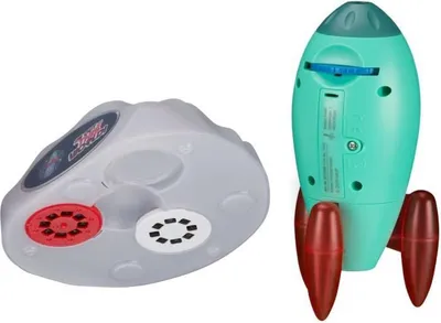 A teal rocket toy and a gray projector base are shown against a white background.