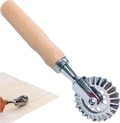 A pasta cutter with a wooden handle and a fluted metal wheel.