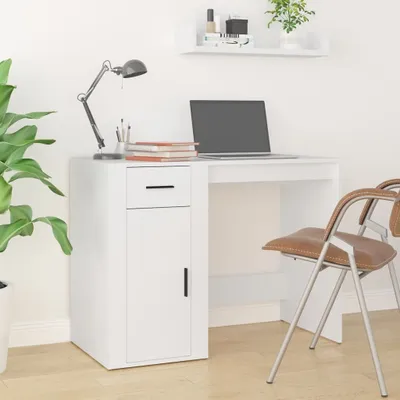 A white desk with a laptop, lamp, and books.