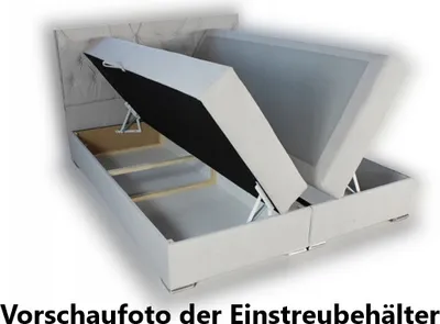 A bed frame with its storage compartments open, showing the internal structure and mechanisms.