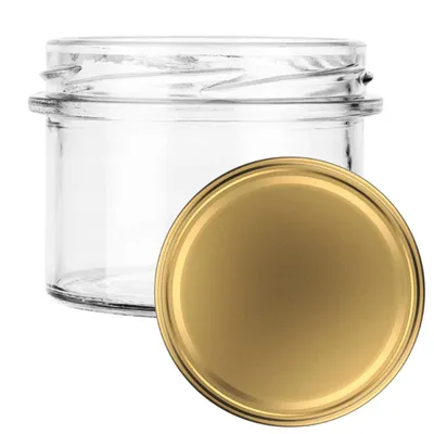A clear glass jar with a gold lid is shown against a white background.