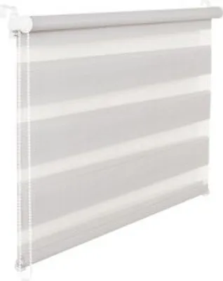 A close-up view of a gray and white roller blind, also known as a day and night blind or zebra blind, hanging in front of a window.