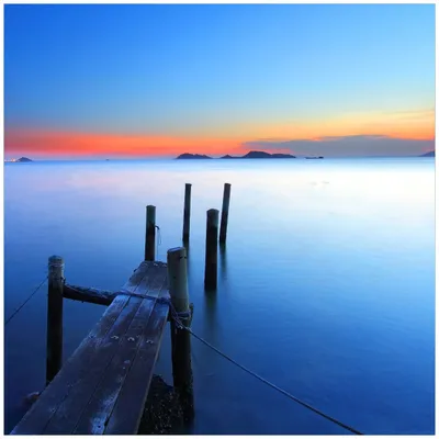 Produktbild von Wallario Magnet für Kühlschrank / Geschirrspüler, magnetisch haftende Folie - 60 x 60 cm, Motiv: Steg im Wasser - Abendstimmung am Meer