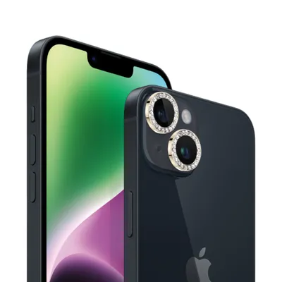 Close-up of two iPhones, one in the foreground with decorative camera lens protectors, and another slightly behind it.