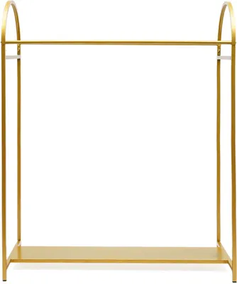 A gold metal garment rack with a shoe shelf.