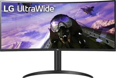 A curved LG UltraWide monitor displaying a video game scene of a fighter pilot in a cockpit.