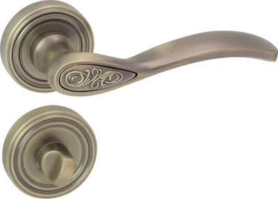 A door handle set with a round rosette and a decorative element on the handle, shown against a white background.