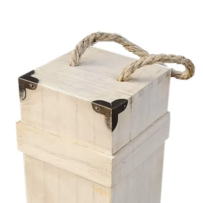 A close-up view of the top of a wooden wine box with a rope handle and metal corner protectors.