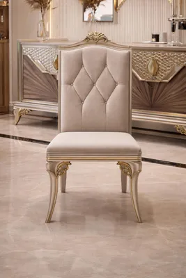 Productafbeelding van Beige eetkamerstoelen met een elegante knoopverdeling en gouden details