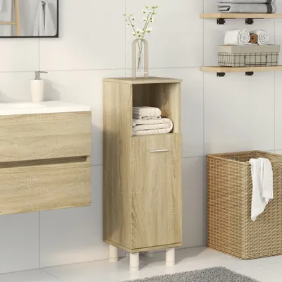 A bathroom setting with a cabinet, sink, and laundry basket.