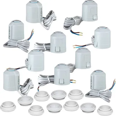 A collection of white thermostatic radiator valves and matching caps arranged on a white background.