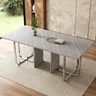 A dining table set in a modern dining room with a large window overlooking a garden.
