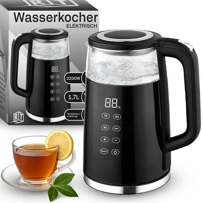 A black electric kettle with a glass body and a digital display, shown next to a box and a cup of tea.